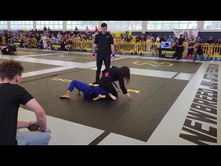 fast and aggressive female bjj gi match ends quickly with triangle choke. newbreed competition